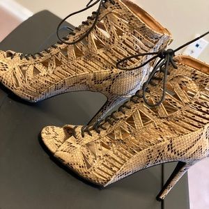 Snakeskin lace up cutout ankle booties.